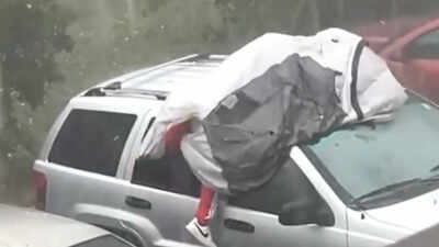 ‘Maybe he forgot insurance’: Florida man tries to protect car during hailstorm by lying on top of it