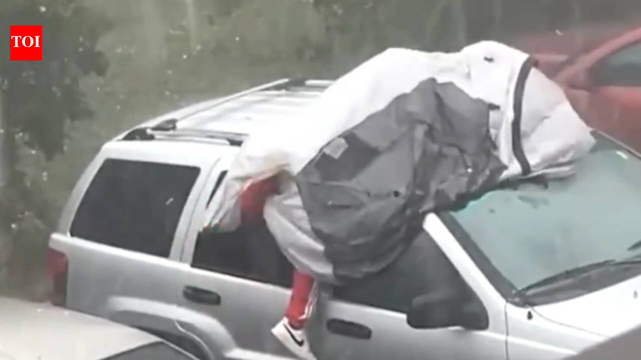 ‘Maybe he forgot insurance’: Florida man tries to protect car during hailstorm by lying on top of it