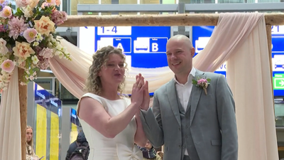 ‘Sustainable wedding’: Couple marries at a busy Netherlands railway station in second-hand outfits as commuters look on