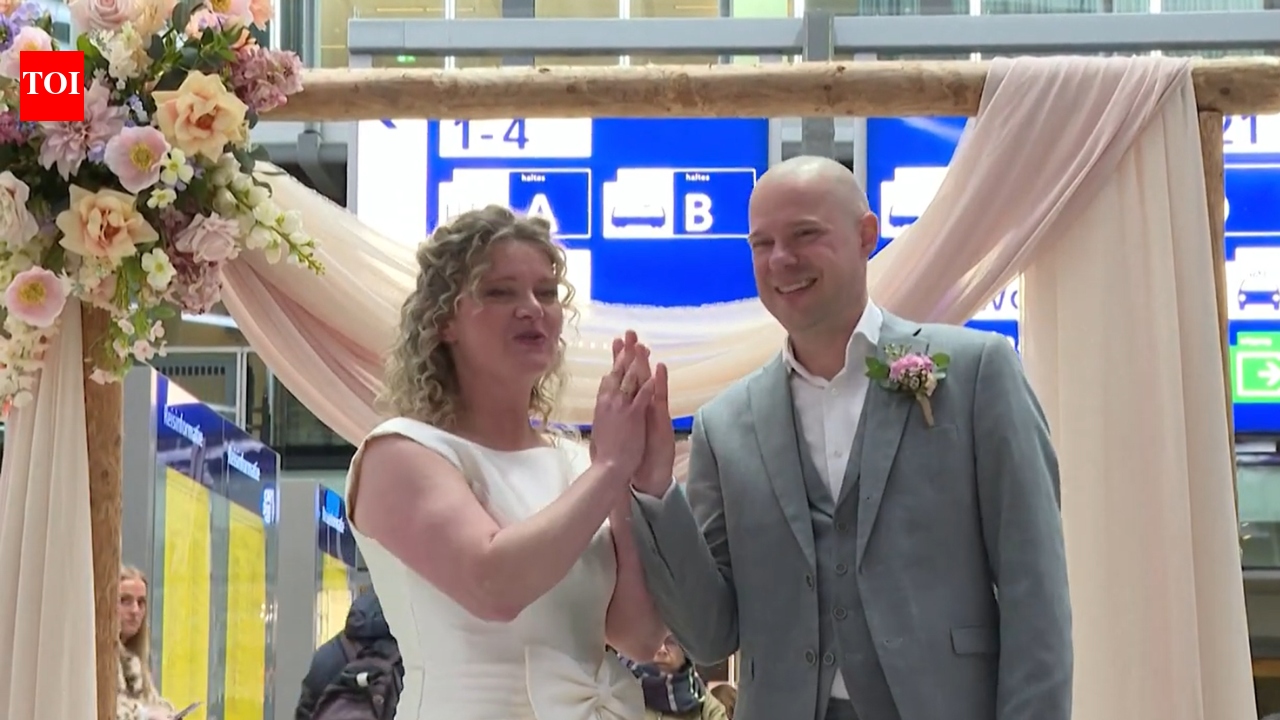 ‘Sustainable wedding’: Couple marries at a busy Netherlands railway station in second-hand outfits as commuters look on