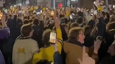 Police arrest two people after Michigan title win as fans light fires and streets in Ann Arbor turn chaotic overnight