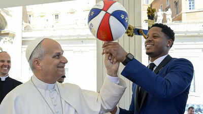 Pope Leo XIV spends quality time with Harlem Globetrotters as he attempts to spin a basketball on his finger