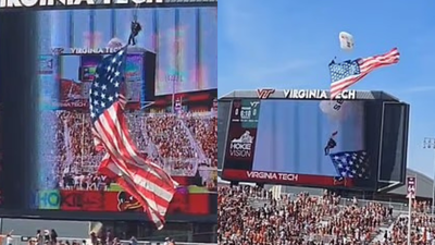 Terrifying moment skydiver hits scoreboard at Virginia Tech spring game after strong wind pushes parachute off landing path