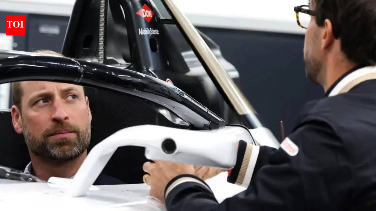 Antonio Felix da Costa and Mitch Evans guide Prince William as he tries a Jaguar Formula E car
