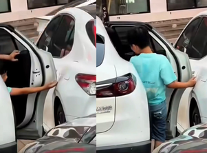 Child opens car door carefully to avoid scratches, a simple moment that reveals powerful parenting