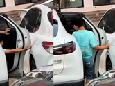 Child opens car door carefully to avoid scratches, a simple moment that reveals powerful parenting