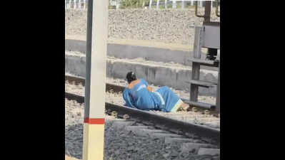 Woman braces rly tracks as train starts moving; escapes unhurt