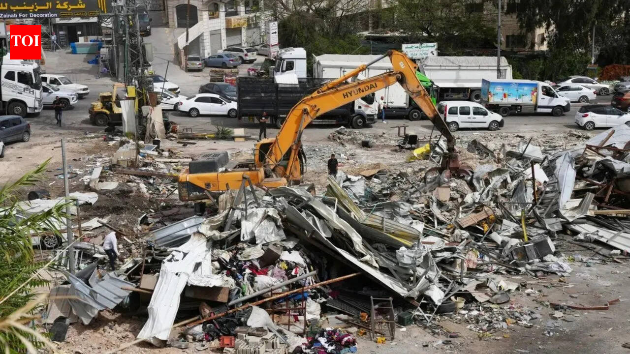 Israeli bulldozers raze about 50 Palestinian shops ahead of settlement-linked road project