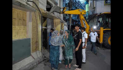 Residents rush out with essentials from house