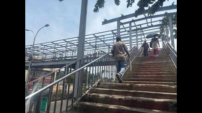 No roof in sight at Fort station’s foot overbridge; commuters brave elements