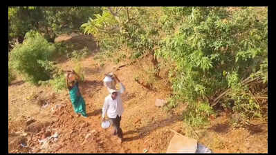 Tribal women brave fall risk in water walk on steep hillsides