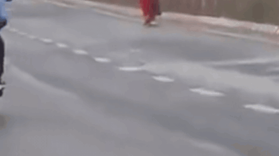 Red outfit, white cloth on head: Video shows woman running with burning object in hands on busy Ahmedabad road