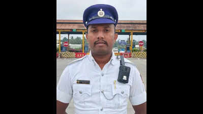 Cop carries specially challenged man on shoulder to cross flooded road in Bengaluru
