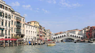 Which famous city is made up of 118 small islands in Italy and attracts millions of visitors each year