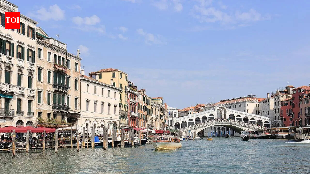 Which famous city is made up of 118 small islands in Italy and attracts millions of visitors each year