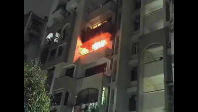 Blaze traps elderly couple, firemen break down door to pull them out