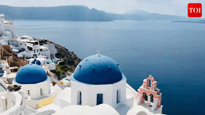 Why are Santorini’s houses painted in white and blue?