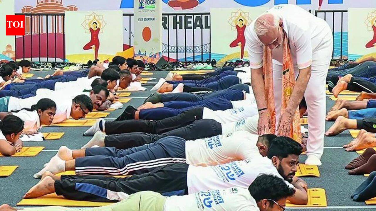 Right way to do it: PM Modi steps off yoga dais to guide participants