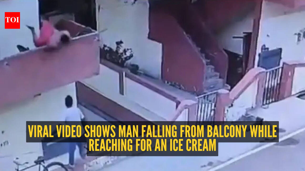Watch: Man falls from first-floor balcony while trying to grab an ice cream from vendor below
