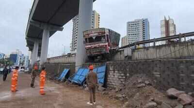 Truck breaks wall, left dangling off flyover on Ghodbunder h’way