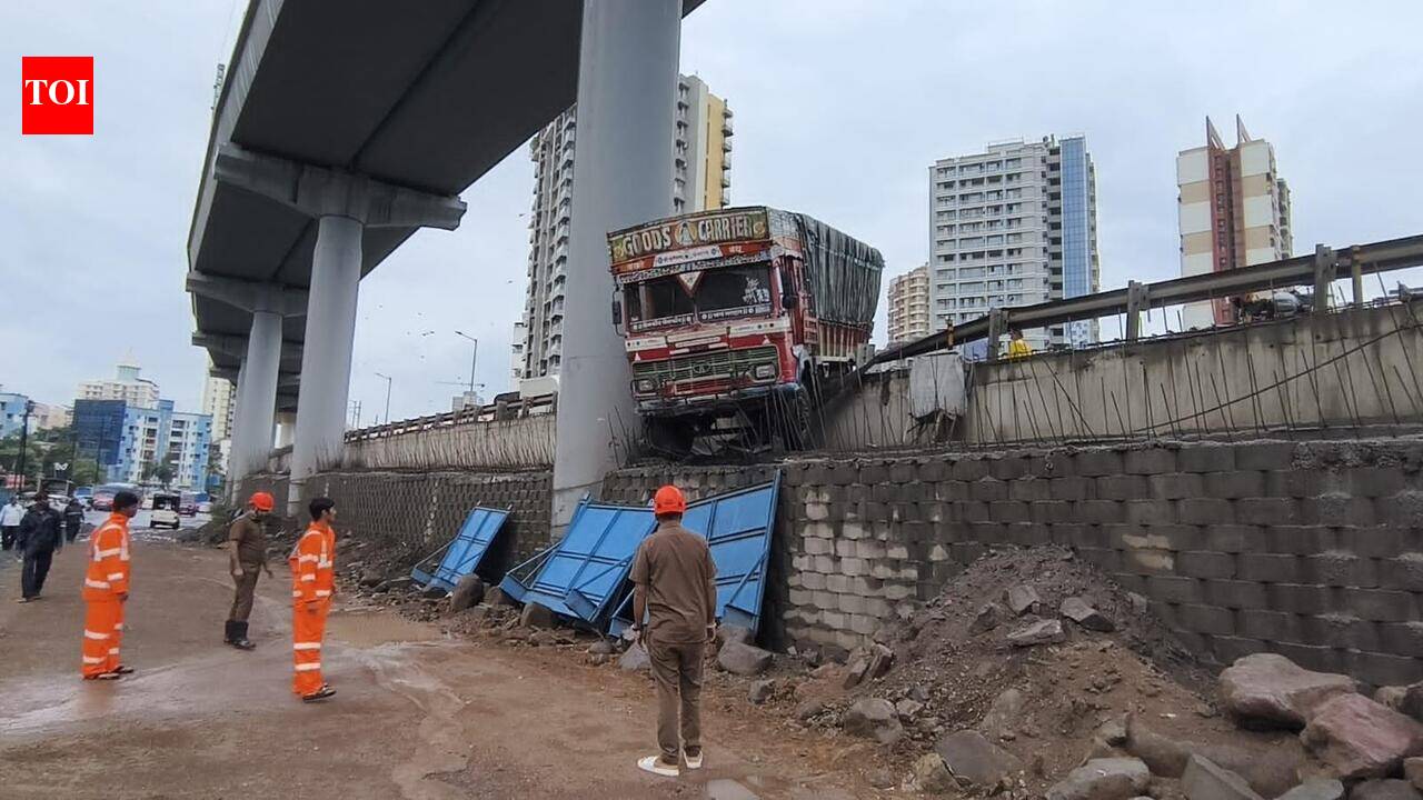 Truck breaks wall, left dangling off flyover on Ghodbunder h’way