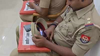 Watch: Azamgarh cop caught watching reels during grievance meet, hides phone inside cap