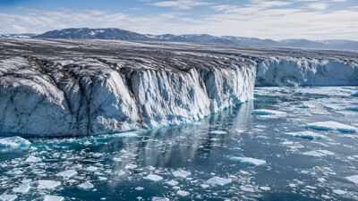 Greenland lost 105 billion tonnes of ice in one year, but scientists say its darkening surface could make future melting worse