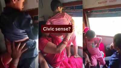 Mother holds child out of moving train window to urinate; video sparks debate on civic sense and child safety during travel