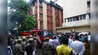 Hundreds of staff stranded amid blaze inside, rain outside