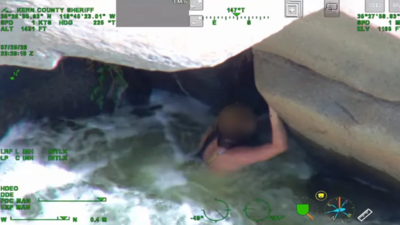 California woman was swept down the Kern River and found clinging beneath a rock; rescuers pulled her from the rapids