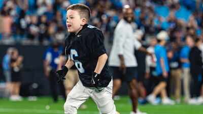 Born with a complex heart condition, a 6-year-old signed with the Carolina Panthers for one day and scored a touchdown in an NFL stadium