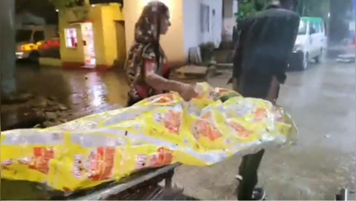 Body lies in rain as hospital awaits papers