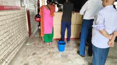 Leaking post office works under buckets in Greater Noida