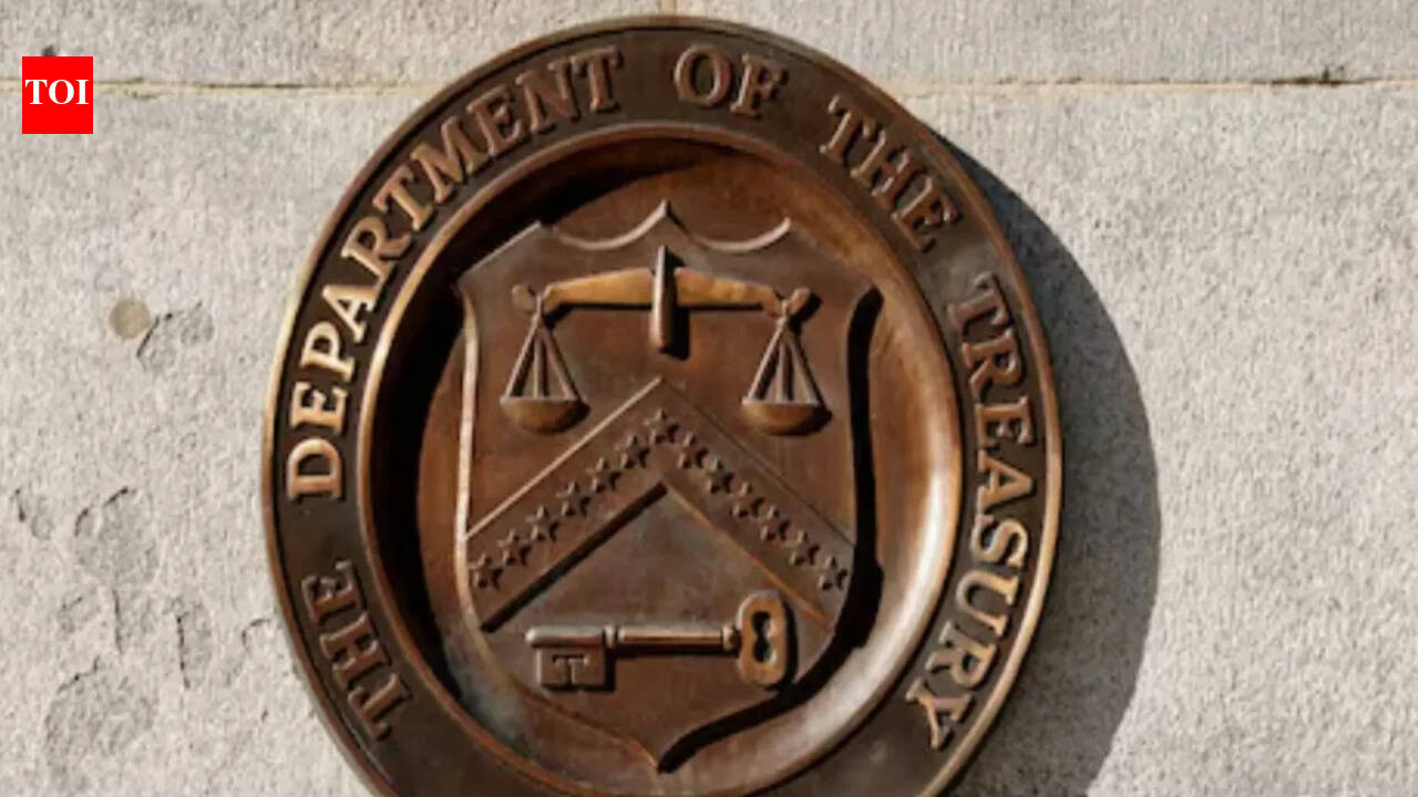 A bronze seal of the Department of the Treasury mounted on a stone wall.