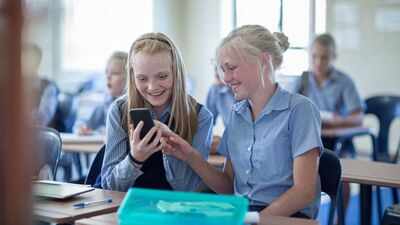 A new Kansas law bars students from accessing phones, earbuds and smartwatches all school day, while one parent group is pushing for tighter iPad limits