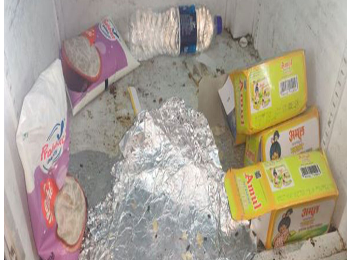 Photo of a D-Mart style supermarket bulk section showing loose grains and flour in open bins