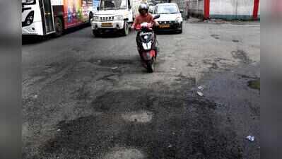 Traffic slows down as potholes show up after rain
