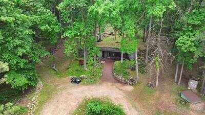 A Missouri engineer bought remote Ozarks land in 1970 and slowly built a reinforced-concrete home into the hillside; more than 50 years later, his son is restoring it room by room