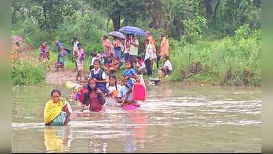 No bridge, villagers carry children on shoulders to school across swollen river