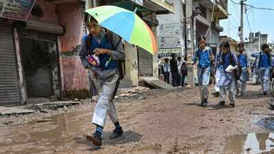 Delhi schoolchildren struggle through waterlogged, broken roads