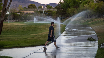 Las Vegas Valley converted 250 million sq ft of lawn to save water, saving 203 billion gallons; researchers found turf removal can raise summer land-surface temperatures about 20°C