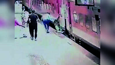 Railway technician pulls passenger to safety as he hangs from moving train
