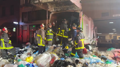 A San Francisco bystander heard screams from a garbage truck after its load had been compacted; 25 firefighters spent more than 2 hours digging a trapped man out alive