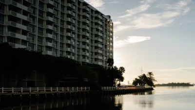 A Miami developer bought most units in a 191-unit waterfront condo and planned a 55-story tower; after holdouts sought $50 million, the three-year fight ended in a settlement