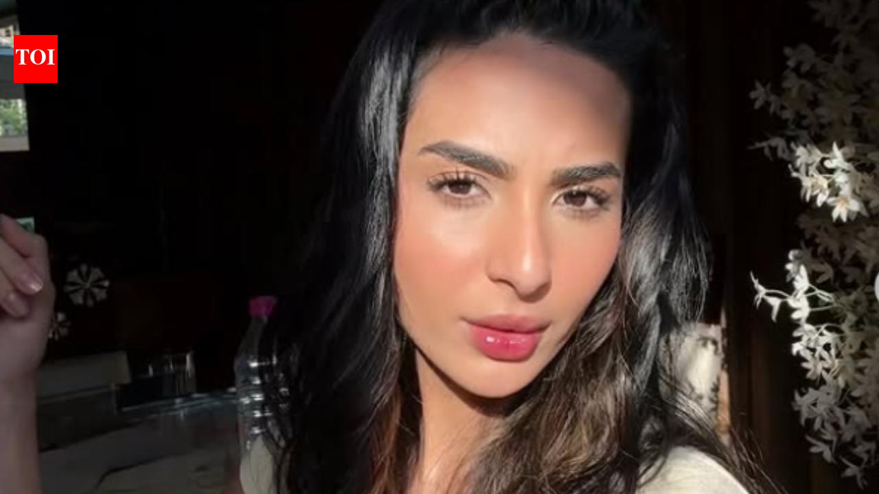 Laila Faisal, a fashion entrepreneur, smiles with a subtle hint of cricketer Abhishek Sharma in the background, representing their rumored relationship.