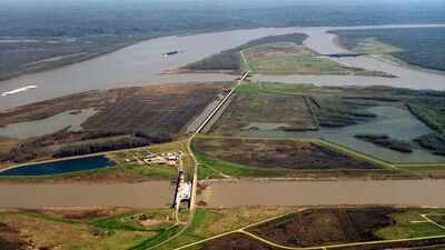 The US built nearly 2,000 km of Mississippi River levees to control floods; the barriers cut sediment off from Louisiana wetlands, helping erase about 4,900 sq km of coastal land