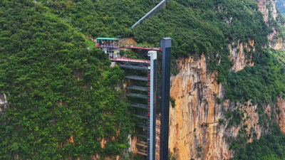 Children in China's Nizhuhe village trekked three hours up and down an 800 metre cliff to go to school; now two elevators and a cable car ride have reduced the journey to half hour