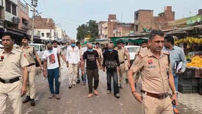 Suspects held for murder paraded through market with shaved heads