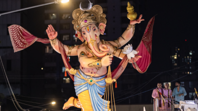 Charming Ganpati idols nestle amid crescent moon and soft clouds