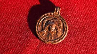 Archaeologists found an 11th-century pendant in Russia showing a Christian saint and a Medusa-like figure